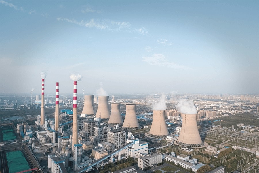 Plant Exterior with smoke billowing from Chimneys