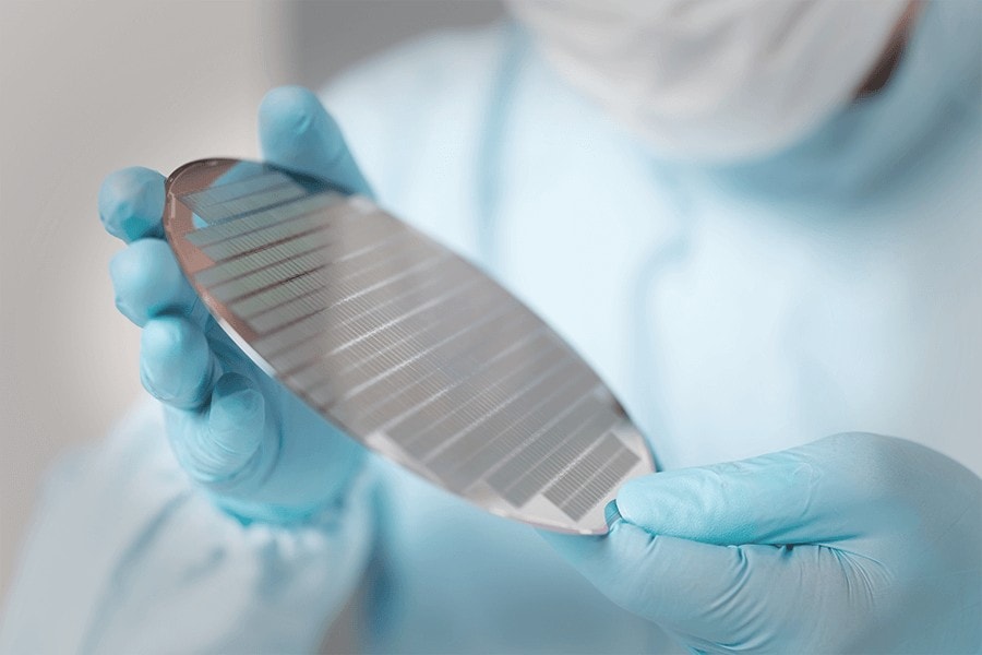 Someone holding a silicon wafer