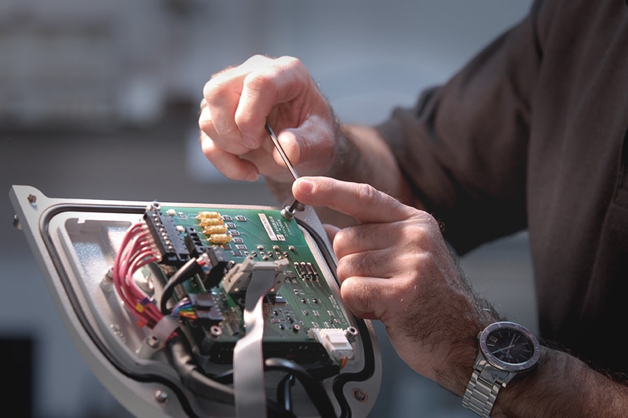 hands assembling gas analyzer circuit board