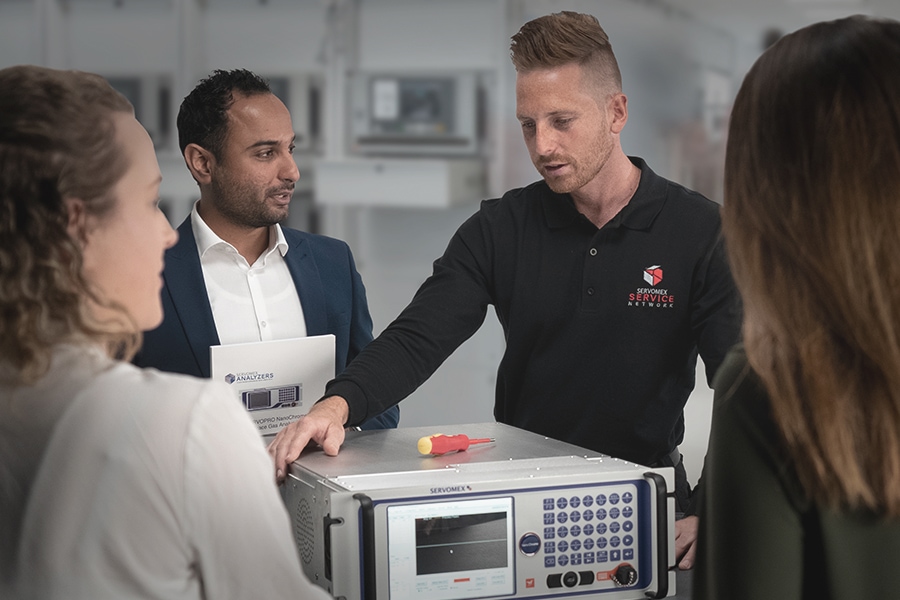 Service Team looking at analyzer