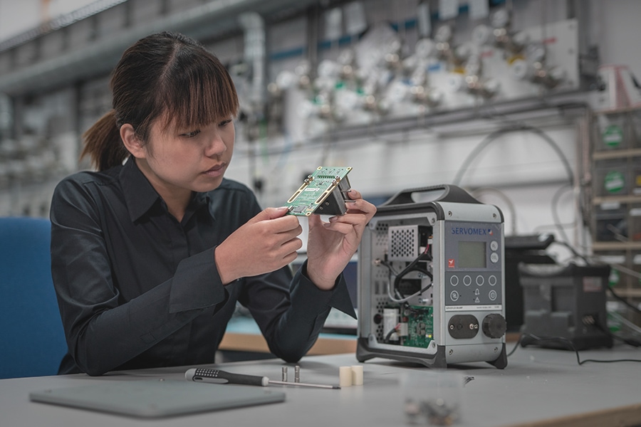 Woman servicing portable gas analyzer