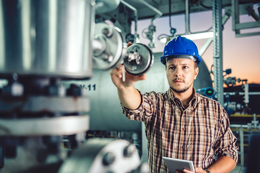 Man using tablet at Natural gas processing facility