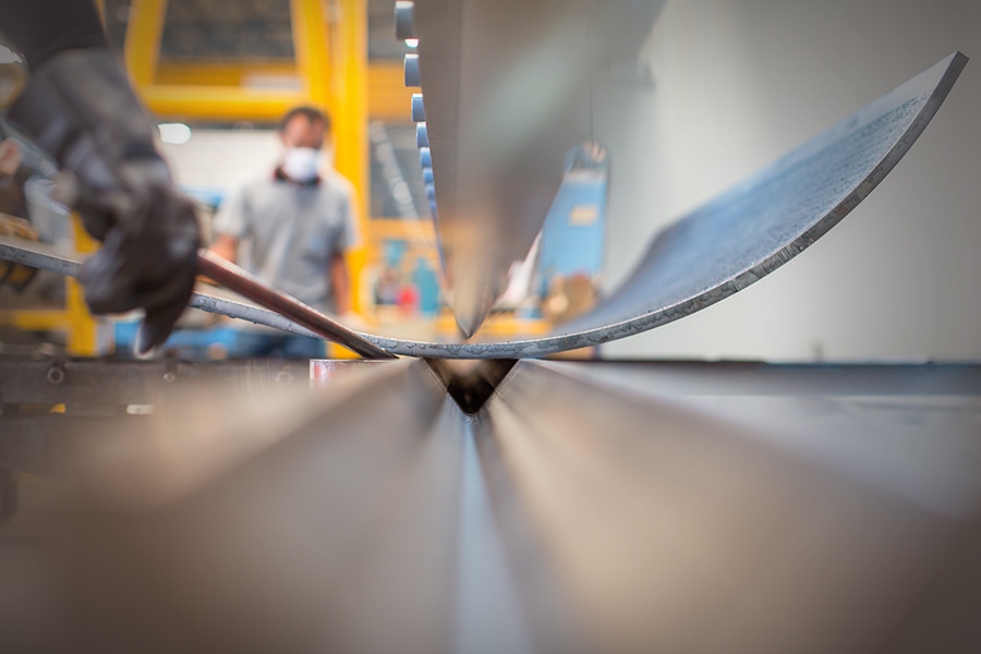 Asian worker in factory at metal workshop - bender