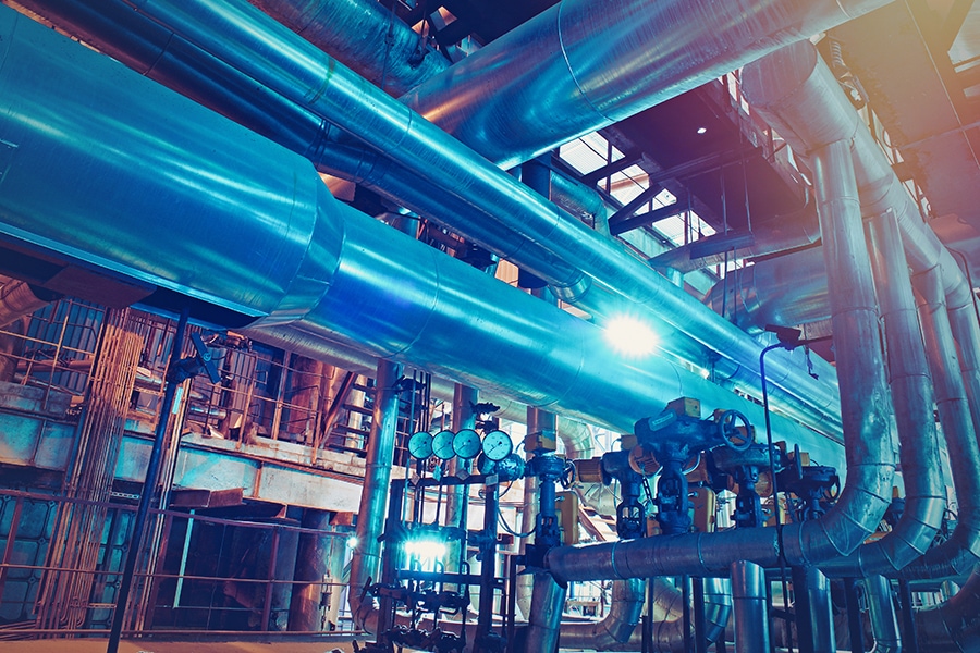 Equipment, cables and piping as found inside of a modern industrial power plant
