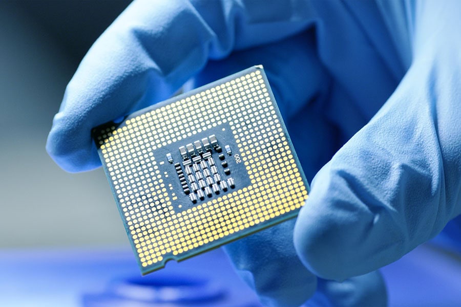 close up presentation of a new generation microchip gloved hand holding piece of technological