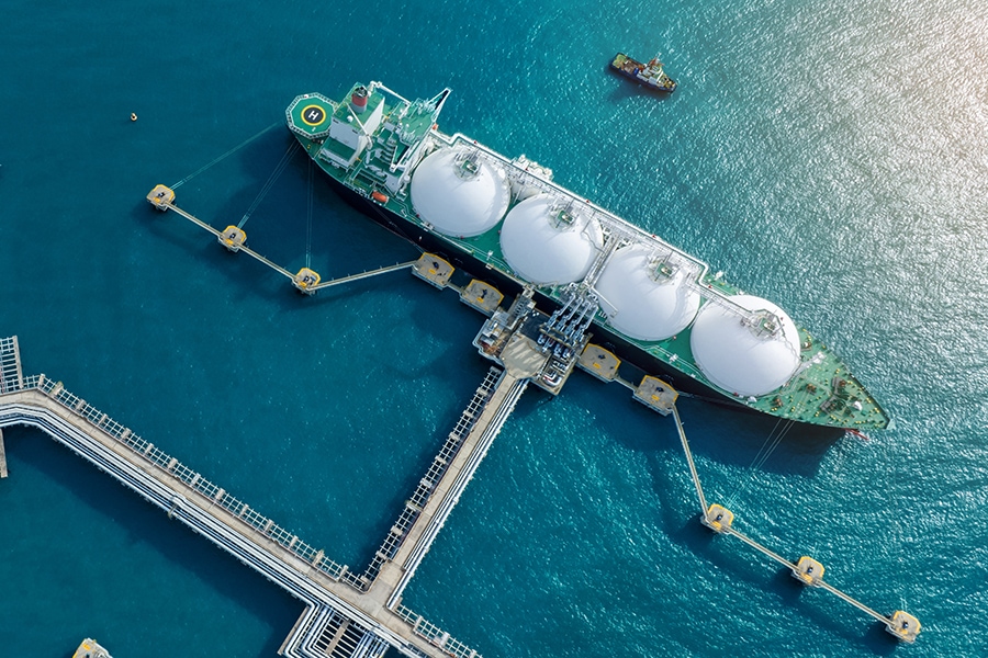 LNG (Liquified Natural Gas) tanker anchored in Gas terminal gas tanks for storage. Oil Crude Gas Tanker Ship. LPG at Tanker Bay Petroleum Chemical or Methane freighter export import transportation and logistics