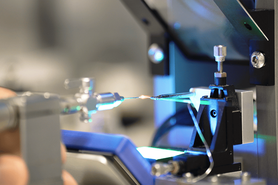 A technician operates a machine to produce wire, demonstrating precision and skill in the manufacturing process.